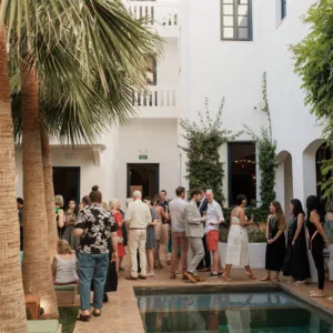 Outdoor wedding reception with long tables under string lights on Menorca