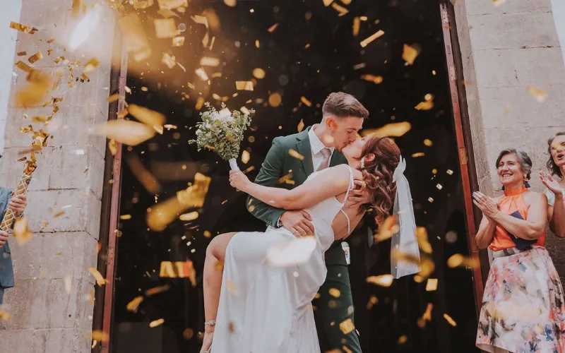 Confetti falling over a couple at an indoor reception