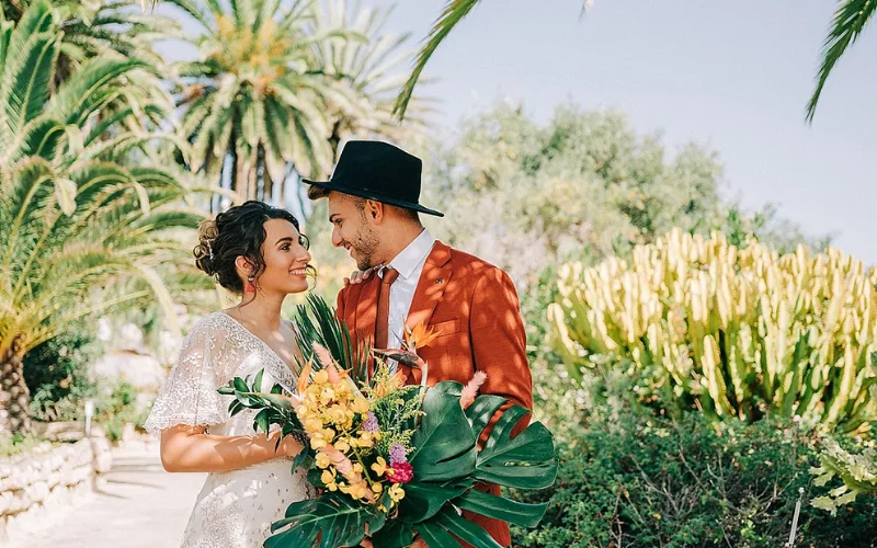 Couple in a subtropical garden of cacti and palms