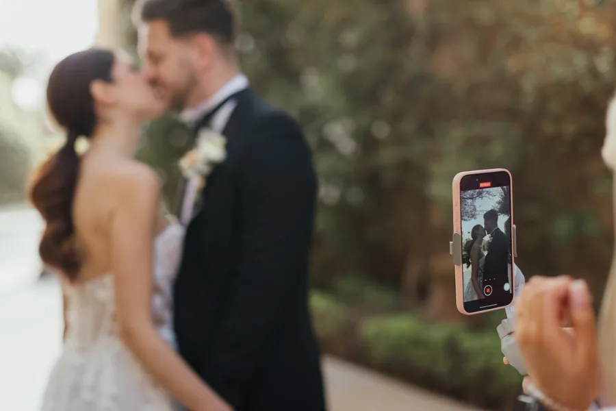 Content creator filming a couple on a phone