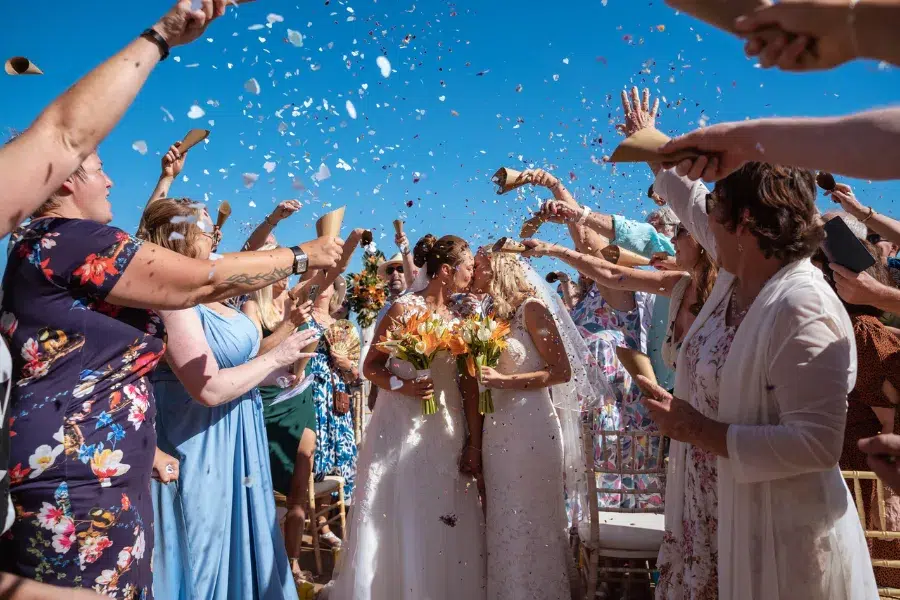 Guests throwing confetti over the couple after the ceremony